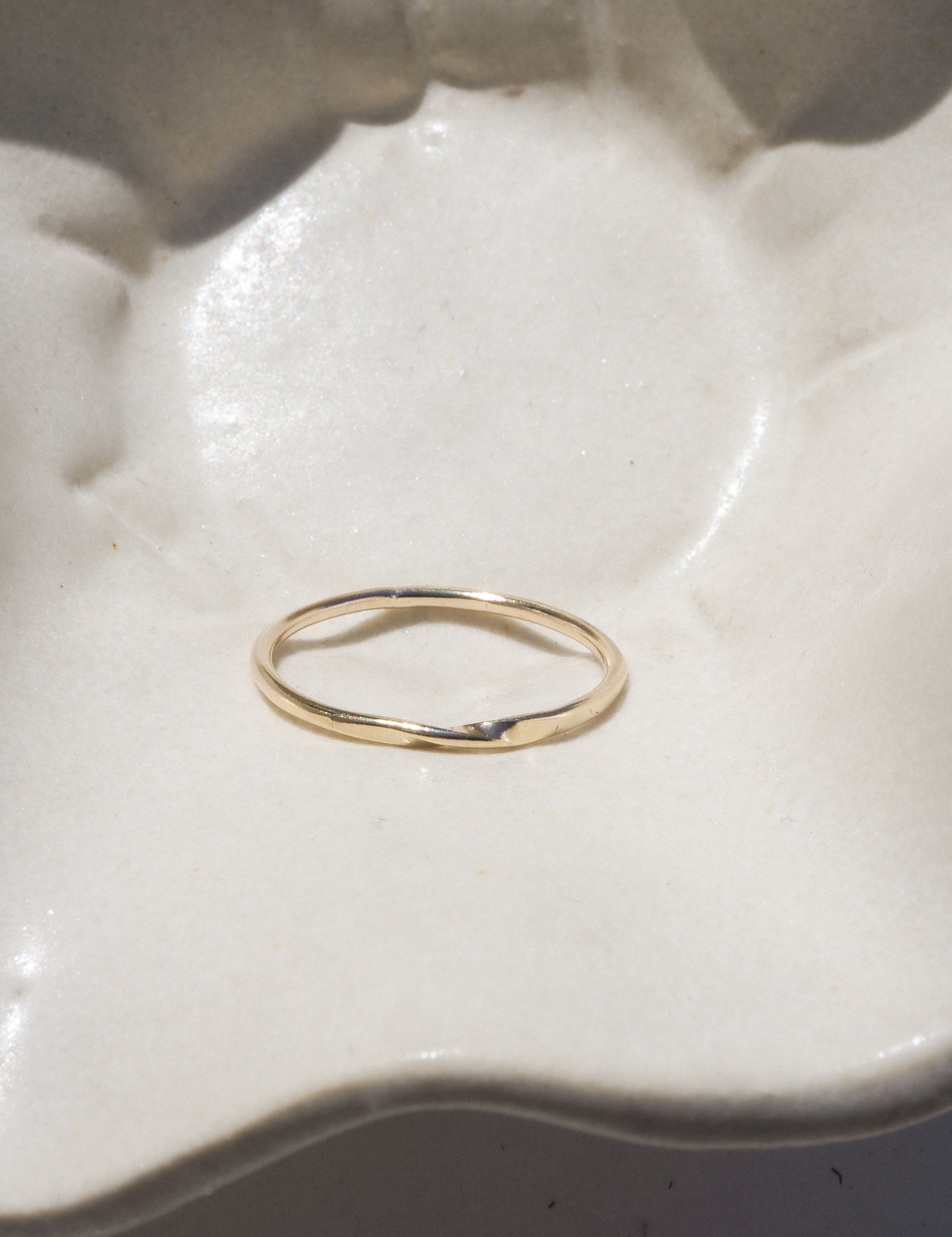 Gold ring on a textured white surface